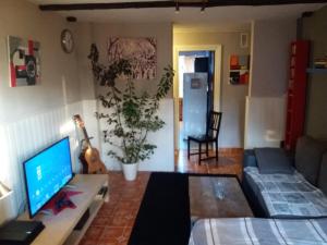 a living room with a couch and a table with a television at near airport in Las Lagunas