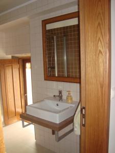 a bathroom with a sink and a mirror at Casa Villar Mayor in Vilar Maior +40 photos