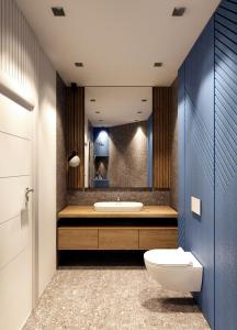 a bathroom with a toilet and a sink and a mirror at Privilege Suites by Central Park in Belgrade