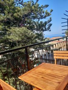 a wooden bench sitting on top of a balcony at Vittorio Veneto Accomodation - Tropea city center in Tropea