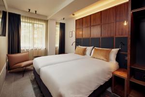 เตียงในห้องที่ Met Hotel Amsterdam