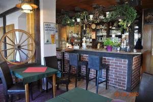 a bar in a restaurant with a brick wall at Pension Di Pino in Aue