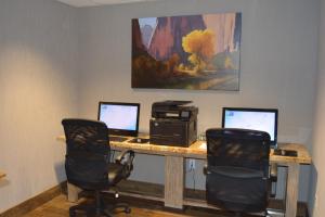 an office with two monitors and a computer on a desk at Holiday Inn Express Springdale - Zion National Park Area, an IHG Hotel in Springdale
