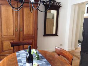 a dining room with a table with a bottle of wine at Ferienwohnung Bode in Lübeck