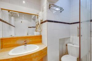 a bathroom with a sink and a toilet at Hôtel du Square d'Anvers in Paris