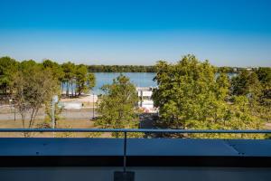 a view of a lake from a balcony at Live Hotels Bordeaux Lac in Bordeaux