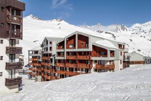 un edificio en la cima de una montaña cubierta de nieve en travelski home classic - Résidence Le Hameau du Borsat 3 stars, en Tignes