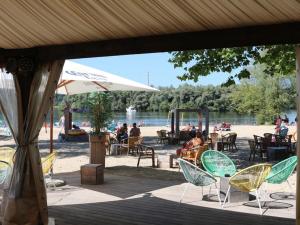 a group of chairs and an umbrella on a beach at Authentic Stays - 6p-apartment in Eijsden
