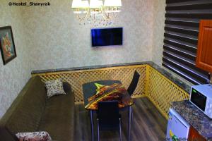 a restaurant with a booth with a table and a couch at SHANYRAK Гостевой дом in Aktobe
