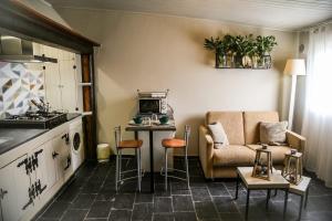 a kitchen and a living room with a couch and a table at Casa de Arriba in Rinlo