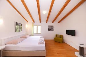 a bedroom with two beds and a tv on the wall at Villa francesca in Starigrad +114 photos