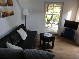 a living room with a couch and a table at Echt Ostfriesenhus in Norden