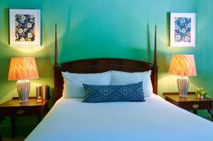 a bedroom with a bed with two lamps on tables at The Mitre, Hampton Court in Kingston upon Thames