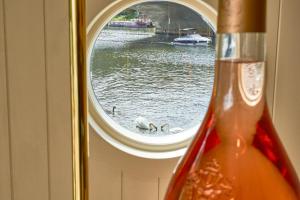a window with two swans swimming in the water at The Mitre, Hampton Court in Kingston upon Thames