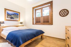 Posteľ alebo postele v izbe v ubytovaní Apartamenty Liptowskie Hale Zakopane
