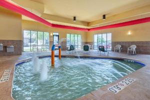 a indoor pool with a water slide in a building at Comfort Suites in Oshkosh