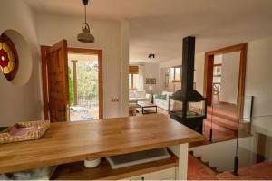 ein Wohnzimmer mit einem Holztisch und einem Herd in der Unterkunft Casa Peña Guardavistas in Derroñadas