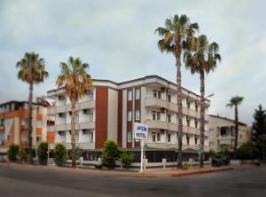 a building with palm trees in front of a street at Afsin Hotel in Antalya