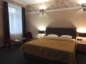 a hotel room with a bed and a window at Вілла Ягуся in Truskavets +13 photos