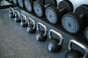 a row of dumbbells on a rack in a gym at Live Hotels Bordeaux Lac in Bordeaux