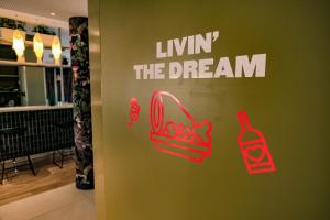 a sign for a store with red shoes and a dream sign at Live Hotels Bordeaux Lac in Bordeaux