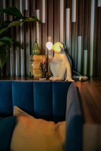 a toy monkey sitting on a table with a lamp at Live Hotels Bordeaux Lac in Bordeaux