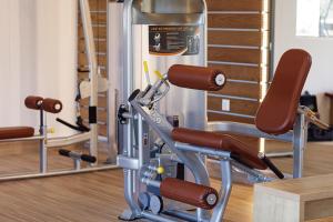 a gym with a treadmill and two chairs at Filion Suites Resort & Spa in Bali