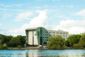 a building next to a body of water at Holiday Inn Express Tamworth by IHG in Tamworth