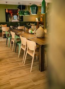a dining room with a long table and chairs at Live Hotels Bordeaux Lac in Bordeaux