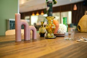 a wooden table with a candle and a candle holder at Live Hotels Bordeaux Lac in Bordeaux