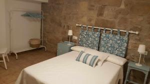 a bedroom with a bed with two pillows on it at Casa Rural els Esclopets in Sanahuja +36 photos