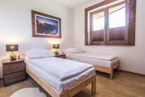 Posteľ alebo postele v izbe v ubytovaní Apartamenty Liptowskie Hale Zakopane