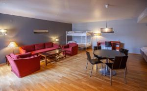 a living room with a red couch and a table at F2 Hotel in Harstad