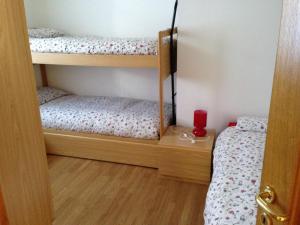 a room with two bunk beds and a red cup at Chalet Madonna di Campiglio CIPAT ZERO22143-AT-ZERO69206 in Madonna di Campiglio
