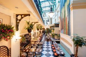 a corridor of a building with tables and flowers at Elite Plaza Hotel in Gothenburg