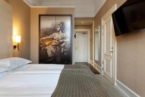 Postel nebo postele na pokoji v ubytování Elite Plaza Hotel
