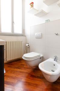 a white bathroom with a toilet and a sink at EASY CENTRAL LOFT - MONZA in Monza
