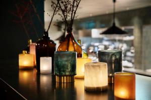 a group of glasses sitting on a table with candles at Elite Park Avenue Hotel in Gothenburg