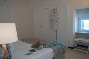 a bedroom with a bed with a hat on it at La Peschiera in Monopoli