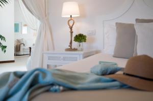 a bedroom with a bed with a hat on it at La Peschiera in Monopoli