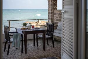 a table and chairs with a view of the ocean at La Peschiera in Monopoli