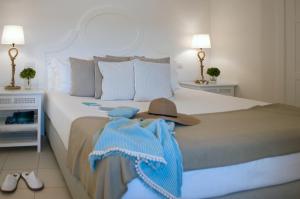 a bedroom with a bed with a hat on it at La Peschiera in Monopoli