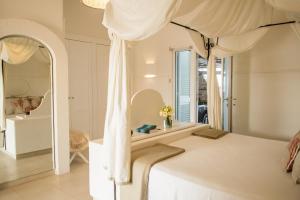 a bedroom with a canopy bed and a mirror at La Peschiera in Monopoli