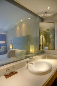 a bathroom with a sink and a large mirror at Crowne Plaza Nairobi Airport by IHG in Nairobi