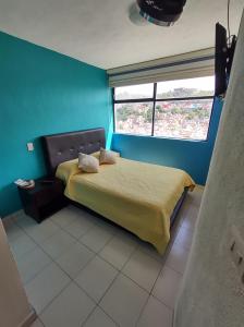 La Lotería Panoramic House & Rooftop by Lunian tesisinde bir odada yatak veya yataklar