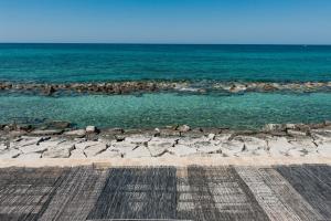 a view of the ocean from a pier at La Peschiera in Monopoli