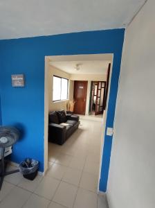 ein Wohnzimmer mit einer blauen Wand und einer Couch in der Unterkunft La Lotería Panoramic House & Rooftop by Lunian in Guanajuato