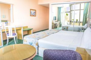 a hotel room with a bed and a table and chairs at Beatriz Costa & Spa in Costa Teguise +60 photos