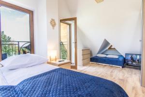 Posteľ alebo postele v izbe v ubytovaní Apartamenty Liptowskie Hale Zakopane
