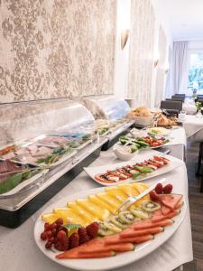 a buffet line with many plates of food at Pension Villa Pangea in Bad Lauterberg